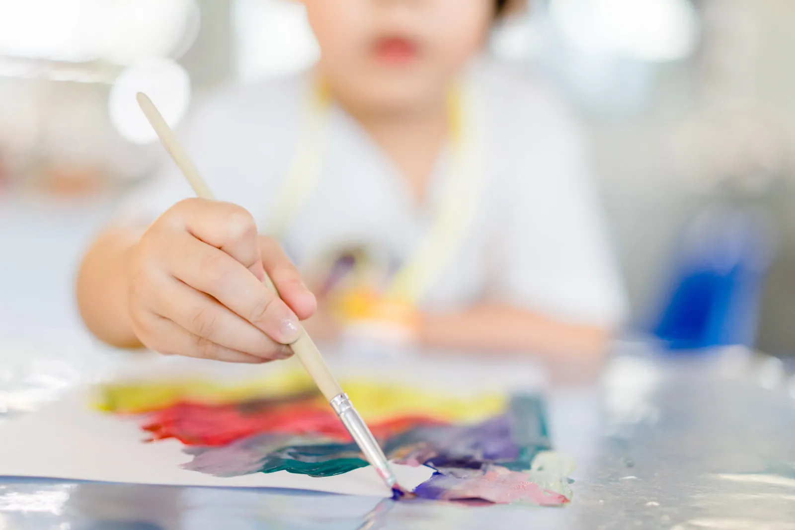 Child painting freely at the easel at Little Jungle Early Learning, Dundas