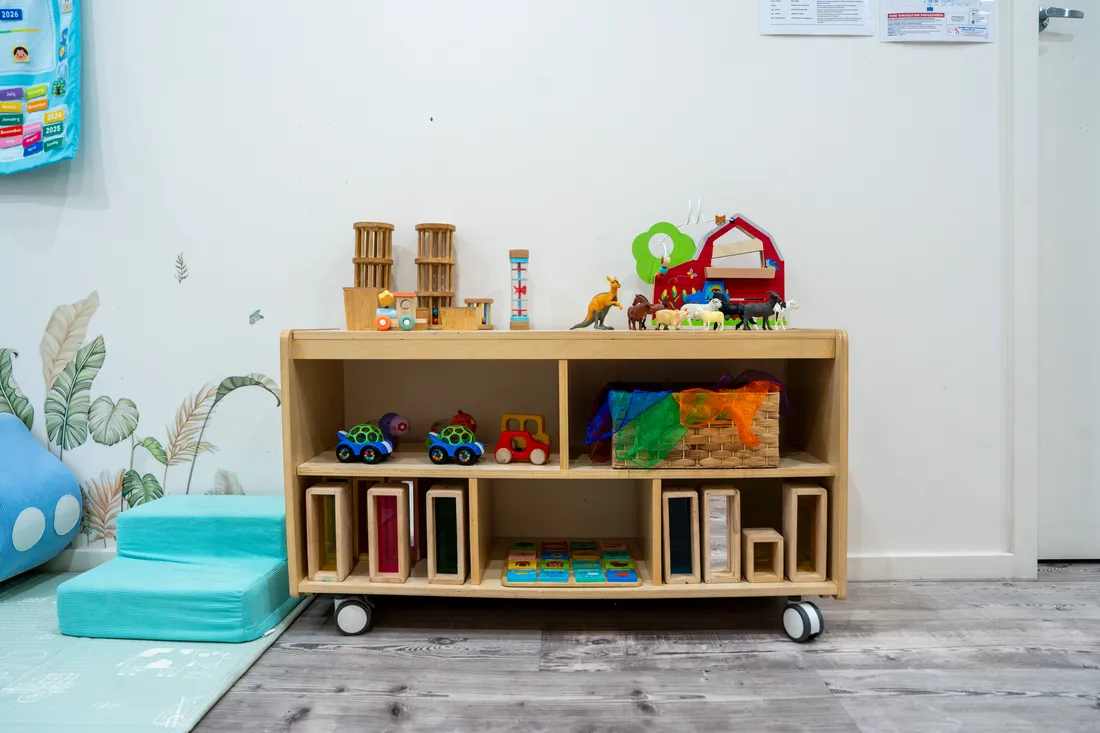 Low open shelving with wooden vehicles and baskets, Little Jungle Dundas
