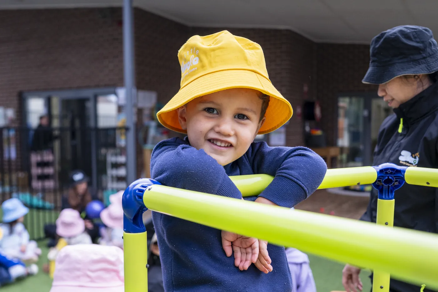 Child in a Little Jungle sun hat on the outdoor climbing dome at Dundas