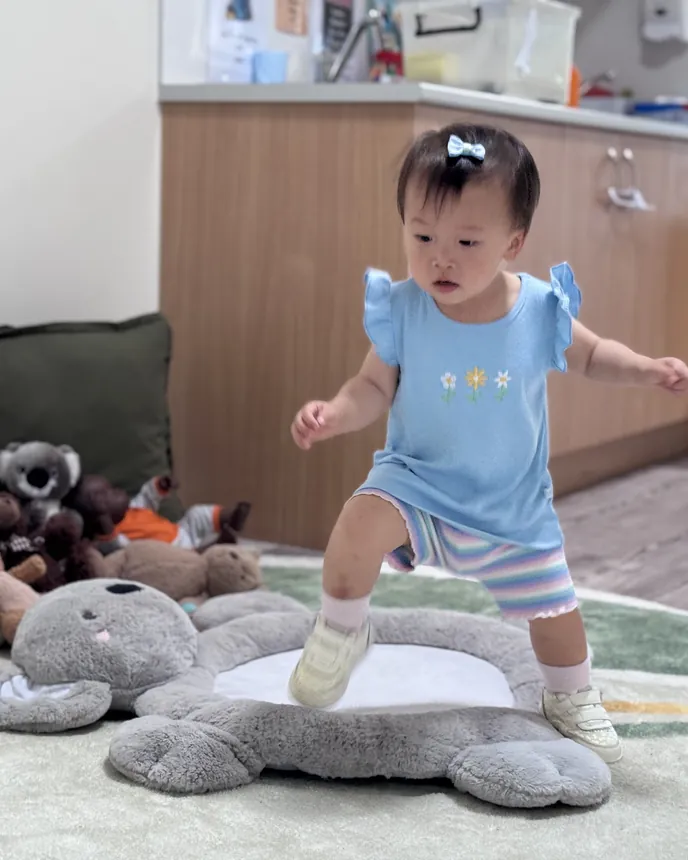 A Cuddle Cubs child finding their feet on the play rug