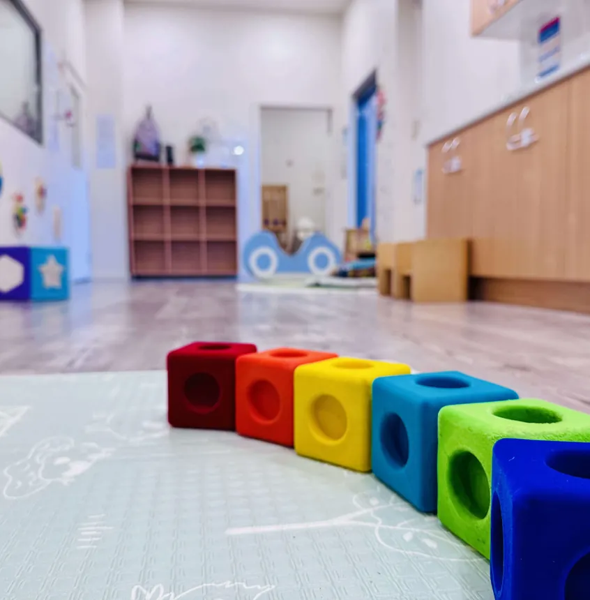 Stacking cubes lined up across the Cuddle Cubs floor