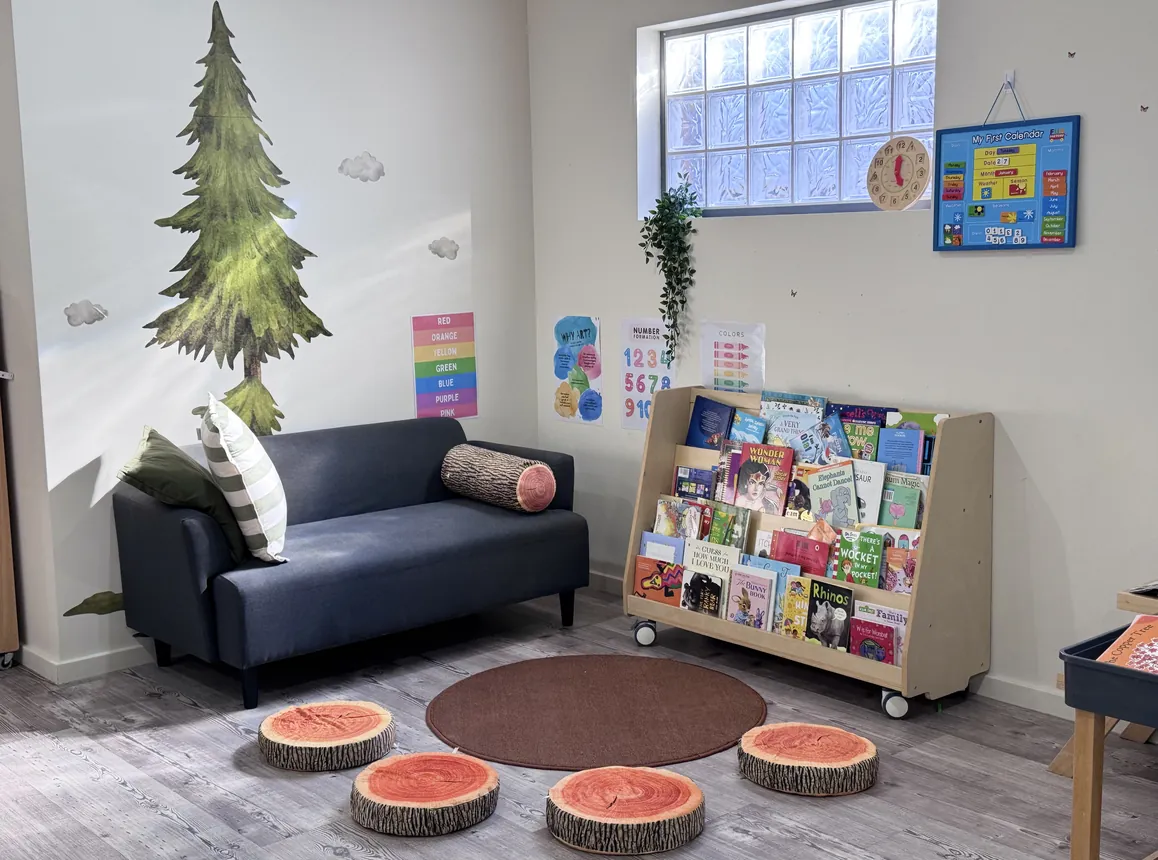 The quiet corner with the book trolley and log stools