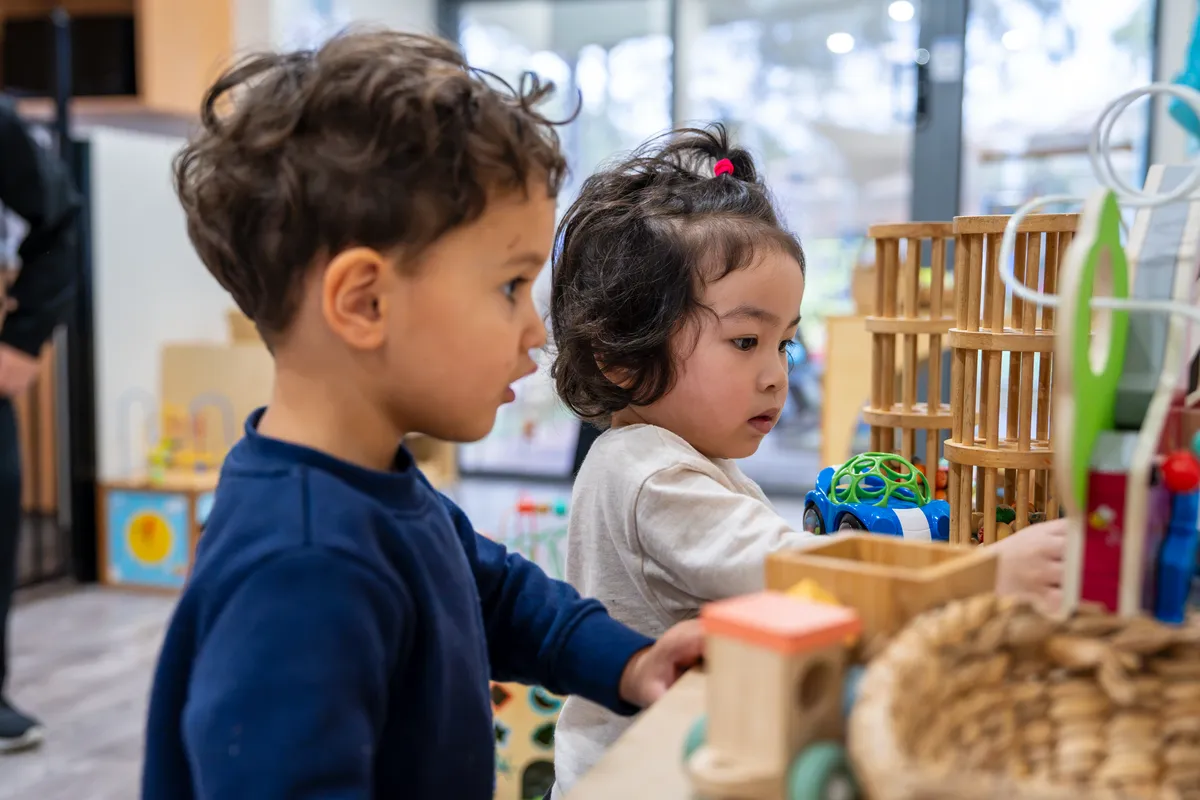 Two preschoolers building at the construction shelf in the Jungle Explorers room, Little Jungle Dundas